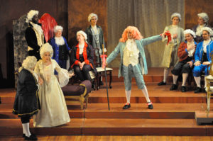 After having danced a minuet with the dancing master (Reuven Aristigueta, in pink wig), Manon (Sabrina Palladino,in white gown) flirts with the elderly Geronte (John Schenkel, far left with back to the audience).