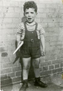Elliott Gould, 3 years old, with a space-gun, outside back wall of local movie theater. Photo courtesy of Elliott Gould